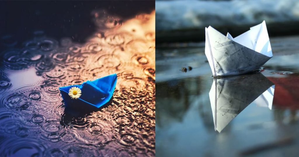 paper boats floating in water during rain