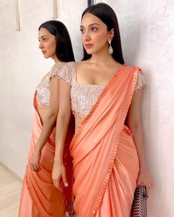 posing with traditional saree in front of a mirror