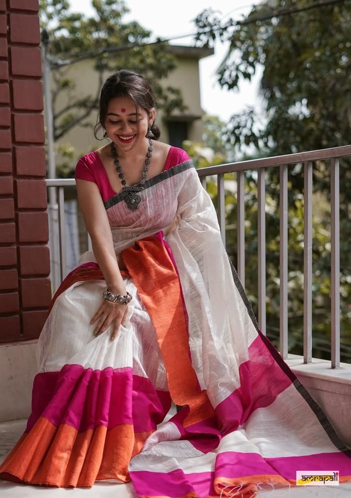 looking down wearing a bengali saree for photoshoot