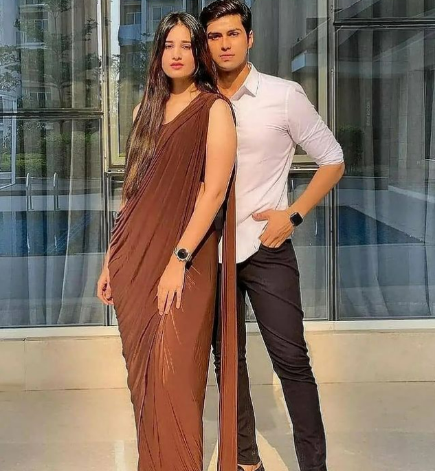 Lovely indian couple in love, wear at saree and elegant suit, posed on  restaurant against window. 10415509 Stock Photo at Vecteezy