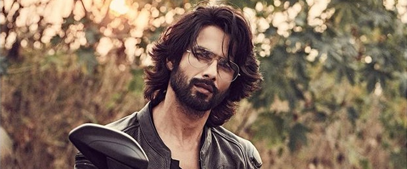 Shahid kapoor in fringed hairstyle while posing with bike