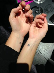 couple small tattoos in symbols