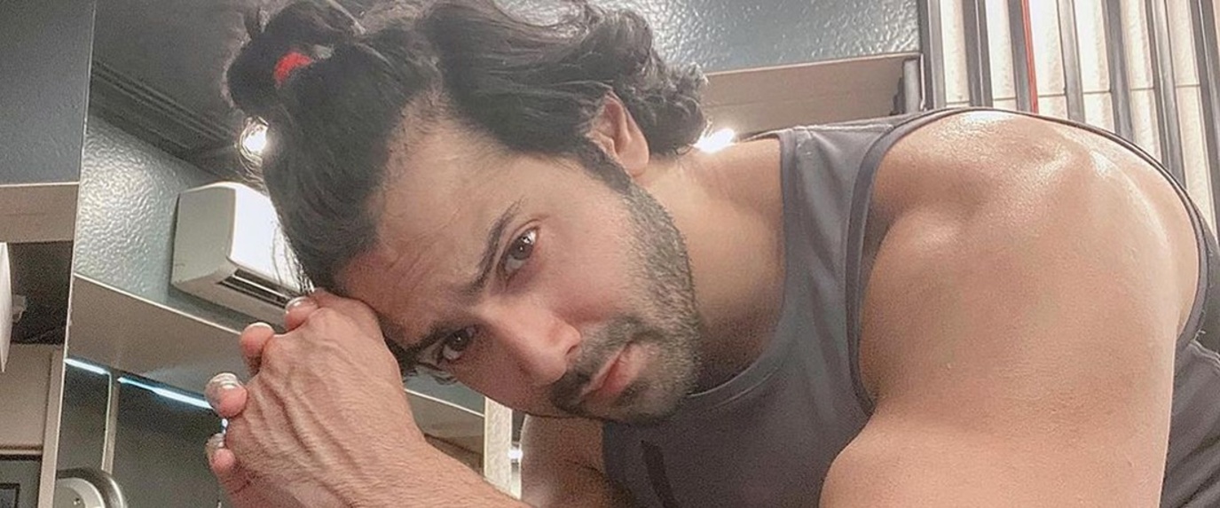 varun dhawan in half ponytail while working out