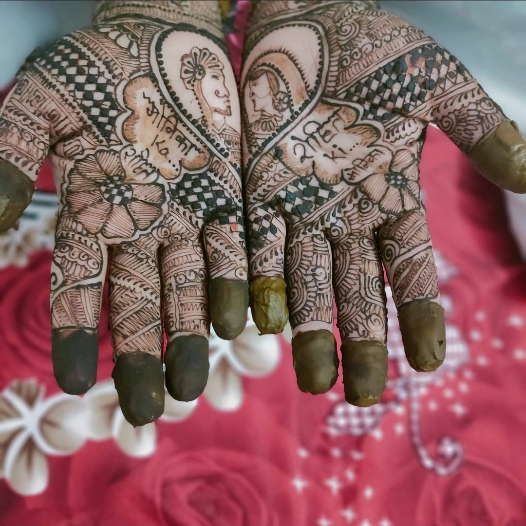 Full hand mehndi design for boys with the name of the bride and groom written with henna