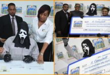 Lottery winner covers face with mask while collecting money to hide from relatives Lottery winner covers face with mask while collecting money to hide from relatives